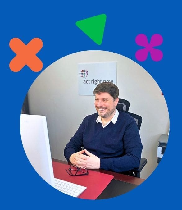 Photo of Dr Gabe at his desk doing an online session with a client