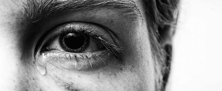 A close up of a crying eye.
